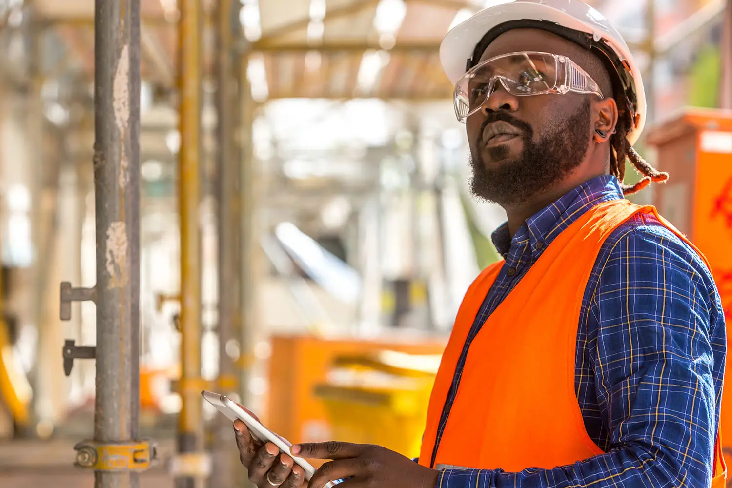Contractor using an iPad on a construction site